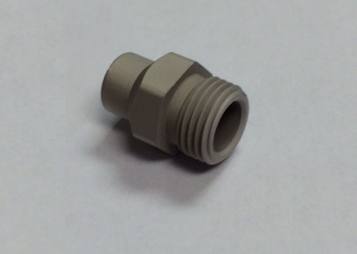 A gray plastic pipe fitting sitting on top of a table.